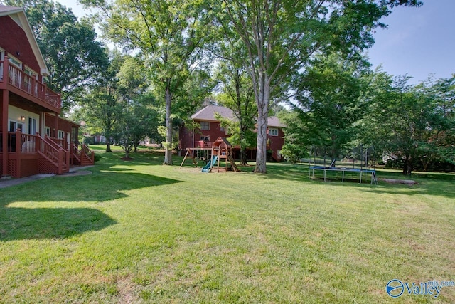view of yard with playground community and a trampoline