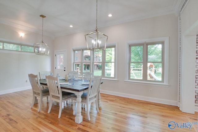dining room featuring crown molding, baseboards, a chandelier, and light wood-type flooring