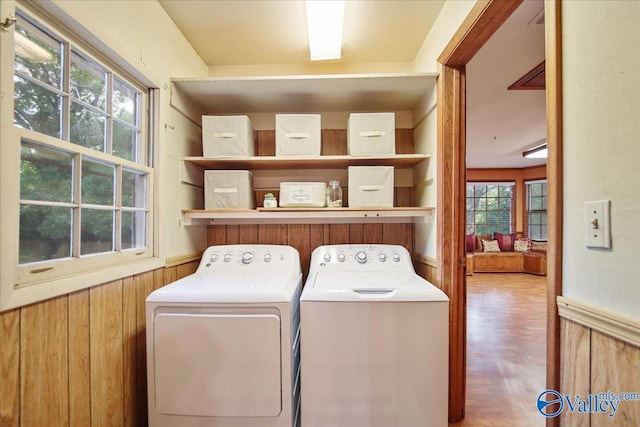 210 Spring Valley Ct SW, Huntsville, AL 35802 - laundry room with washing machine and dryer, wood walls, a wainscoted wall, and wood finished floors