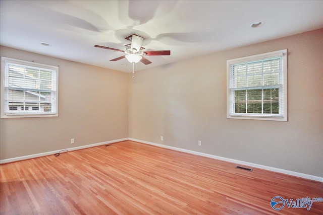 210 Spring Valley Ct SW, Huntsville, AL 35802 - unfurnished room featuring healthy amount of natural light, light wood-style flooring, and a ceiling fan