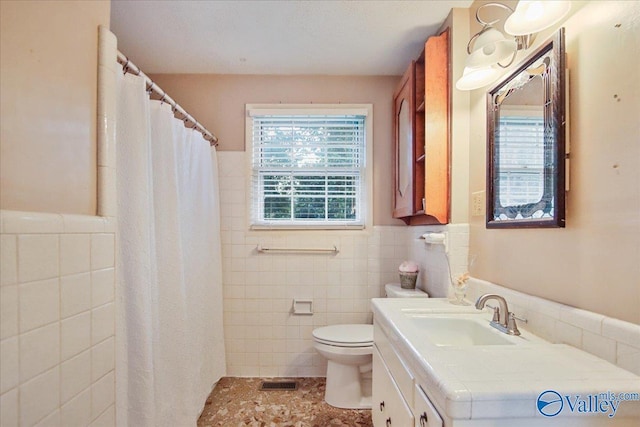 210 Spring Valley Ct SW, Huntsville, AL 35802 - bathroom featuring tile walls, vanity, wainscoting, curtained shower, and tile patterned flooring
