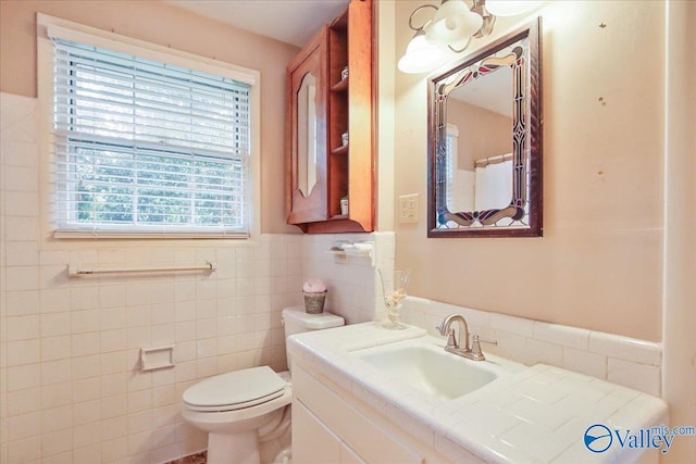 210 Spring Valley Ct SW, Huntsville, AL 35802 - full bath featuring tile walls, vanity, a wainscoted wall, and curtained shower