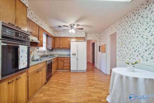 210 Spring Valley Ct SW, Huntsville, AL 35802 - kitchen with black appliances, wallpapered walls, under cabinet range hood, light wood-style flooring, and a ceiling fan