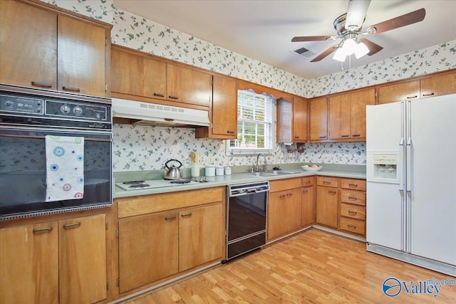 210 Spring Valley Ct SW, Huntsville, AL 35802 - kitchen with black appliances, under cabinet range hood, light wood-style flooring, ceiling fan, and brown cabinetry