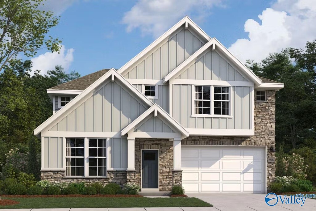view of front of property featuring a garage, board and batten siding, concrete driveway, and stone siding