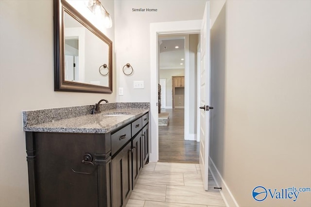 MCKINLEY-A1 Capshaw Rd, Athens, AL 35613 - bathroom featuring vanity, baseboards, marble look tiles, and recessed lighting