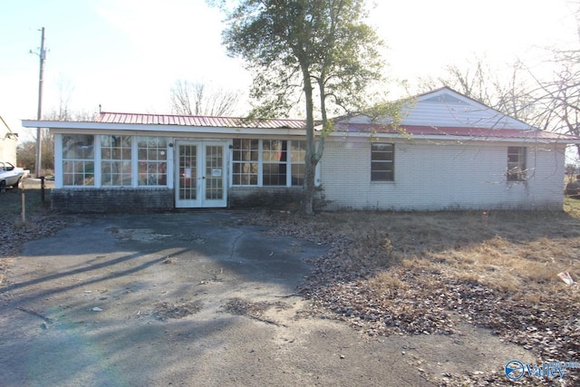 back of property featuring french doors and a sunroom