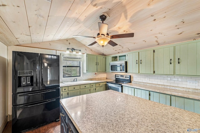 kitchen with lofted ceiling, dark wood-type flooring, green cabinetry, appliances with stainless steel finishes, and light stone counters