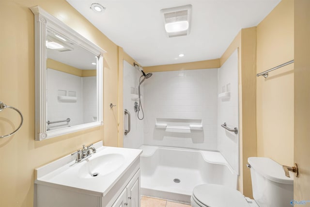 bathroom featuring tile patterned floors, vanity, toilet, and tiled shower