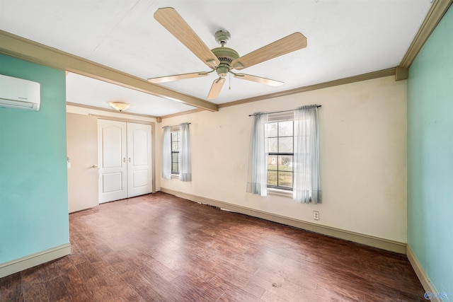 empty room featuring ceiling fan, dark wood-type flooring, a wall mounted air conditioner, and ornamental molding