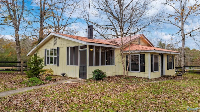 view of side of home with a sunroom