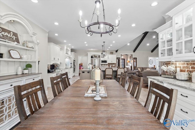 dining room with vaulted ceiling with beams, recessed lighting, and a notable chandelier