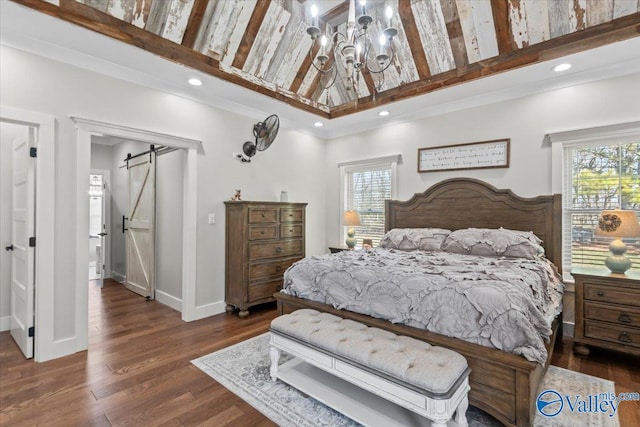 bedroom featuring a barn door, baseboards, dark wood-type flooring, a notable chandelier, and recessed lighting