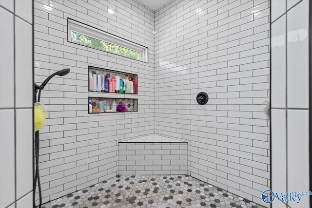 full bath featuring tiled shower