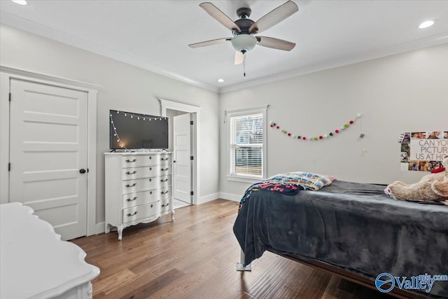 bedroom featuring ornamental molding, recessed lighting, baseboards, and wood finished floors