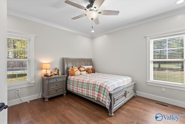 bedroom with dark wood-style flooring, visible vents, baseboards, and multiple windows