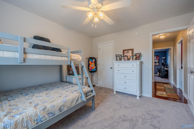 bedroom featuring light colored carpet and ceiling fan