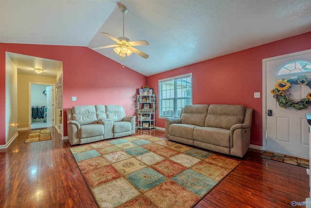 living room featuring vaulted ceiling, dark hardwood / wood-style floors, and ceiling fan