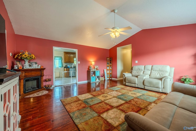 living room featuring lofted ceiling, dark wood-type flooring, and ceiling fan