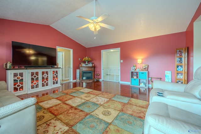 living room featuring hardwood / wood-style floors, vaulted ceiling, and ceiling fan