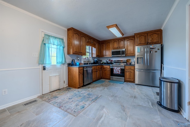 kitchen featuring appliances with stainless steel finishes and ornamental molding