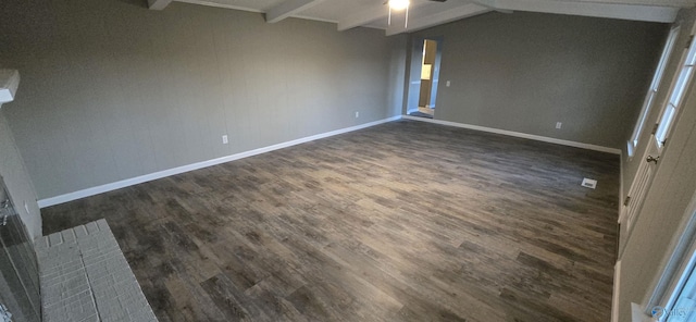 unfurnished room with vaulted ceiling with beams, dark hardwood / wood-style floors, and ceiling fan