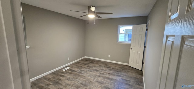 spare room with ceiling fan and dark hardwood / wood-style flooring