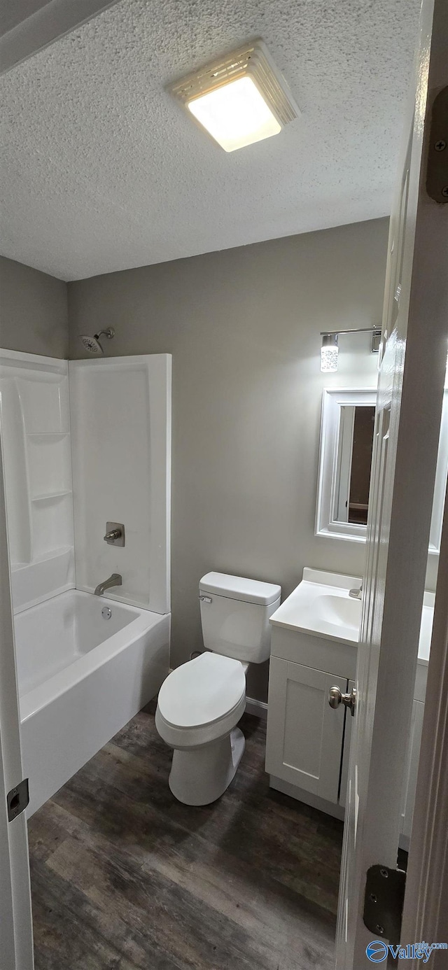 full bathroom featuring wood-type flooring, vanity, toilet, and shower / bathtub combination