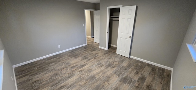 unfurnished bedroom featuring a closet and dark wood-type flooring