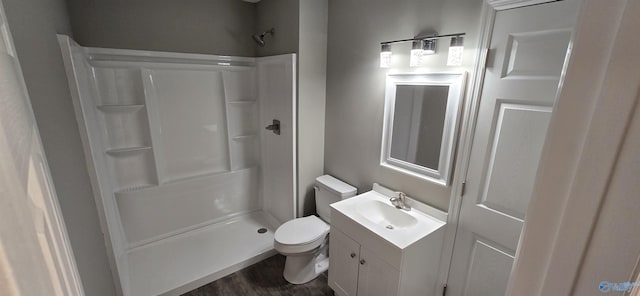bathroom featuring hardwood / wood-style floors, vanity, toilet, and walk in shower