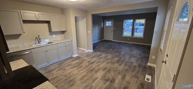 kitchen with dishwasher, dark wood-type flooring, white cabinets, sink, and a textured ceiling