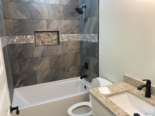 full bathroom featuring vanity, toilet, and tiled shower / bath