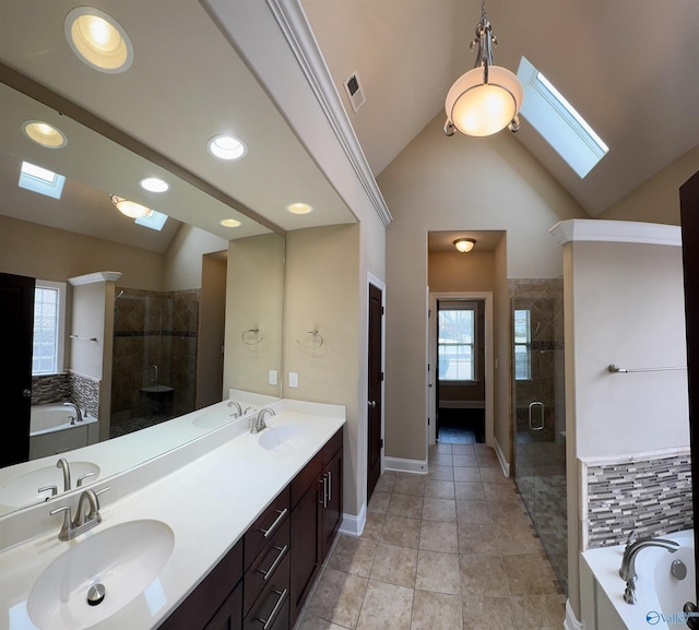 bathroom with vanity, tile patterned flooring, lofted ceiling with skylight, and plus walk in shower