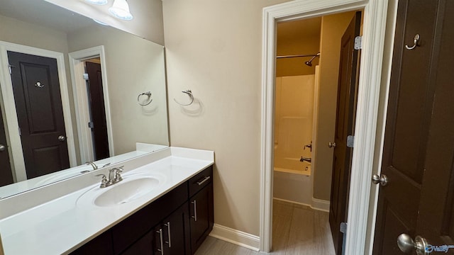 bathroom featuring vanity, tub / shower combination, and hardwood / wood-style floors