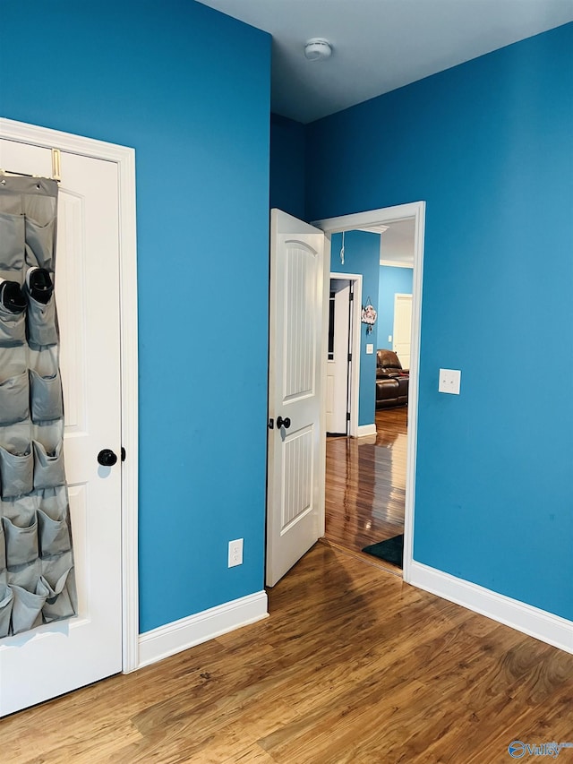 unfurnished bedroom featuring wood-type flooring and a closet