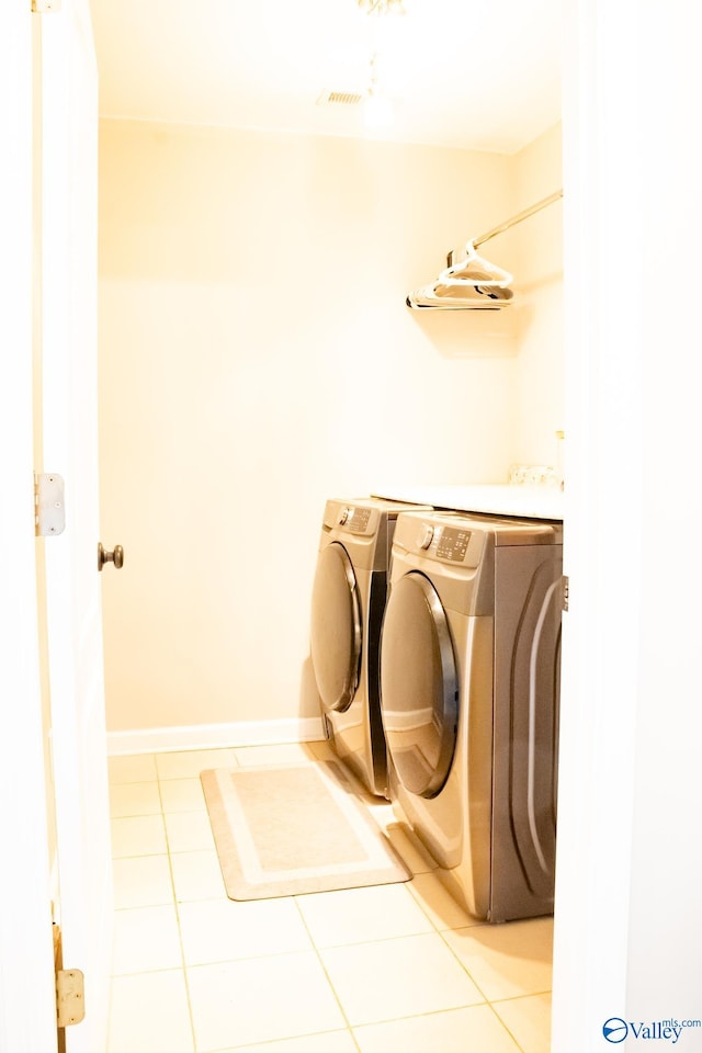 1508 Berrivine Dr, Hartselle, AL 35640 - laundry room with washing machine and dryer and light tile patterned floors