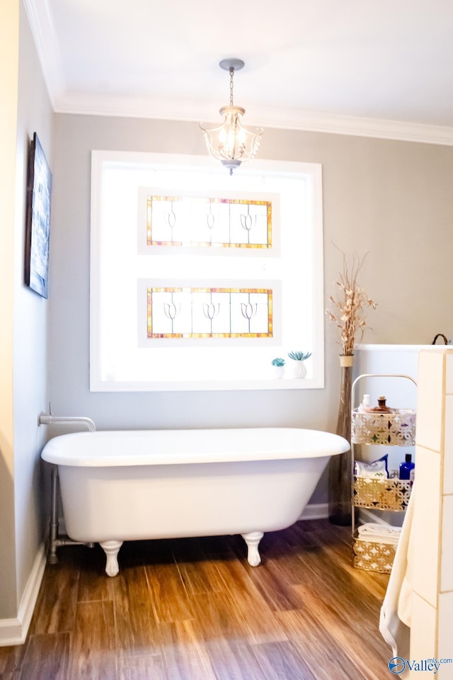 1508 Berrivine Dr, Hartselle, AL 35640 - full bath featuring wood finished floors, baseboards, a freestanding bath, and crown molding