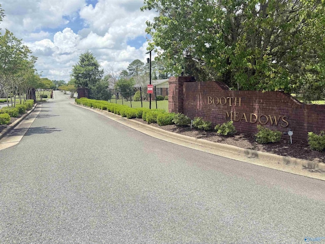 1508 Berrivine Dr, Hartselle, AL 35640 - view of asphalt street with curbs, traffic signs, and a gated entry