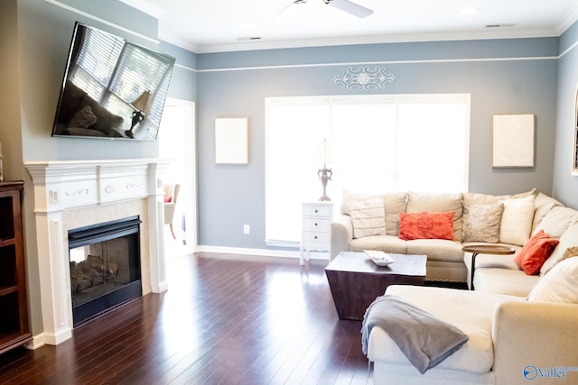 1508 Berrivine Dr, Hartselle, AL 35640 - living area featuring ornamental molding, dark wood-style floors, a glass covered fireplace, ceiling fan, and baseboards