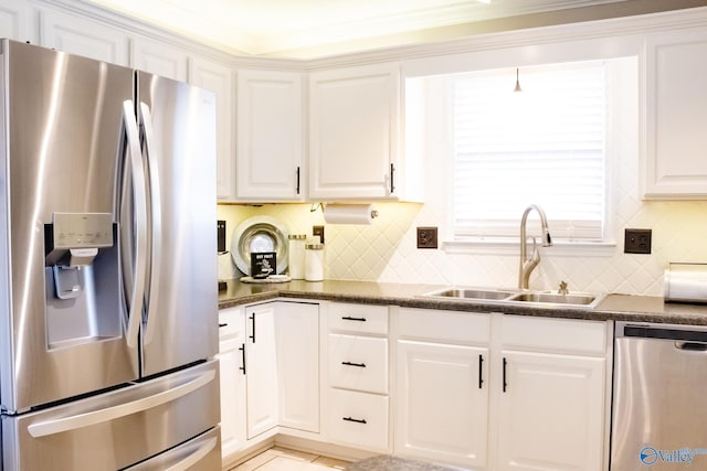1508 Berrivine Dr, Hartselle, AL 35640 - kitchen featuring stainless steel appliances, a sink, dark countertops, tasteful backsplash, and white cabinets