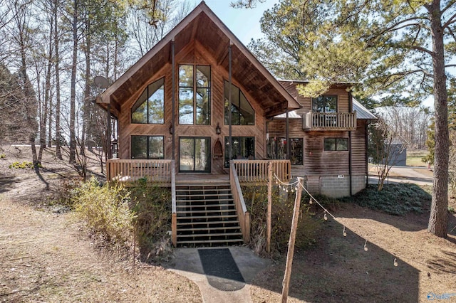 rear view of house featuring stairway