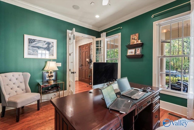 office area with crown molding and light wood-type flooring