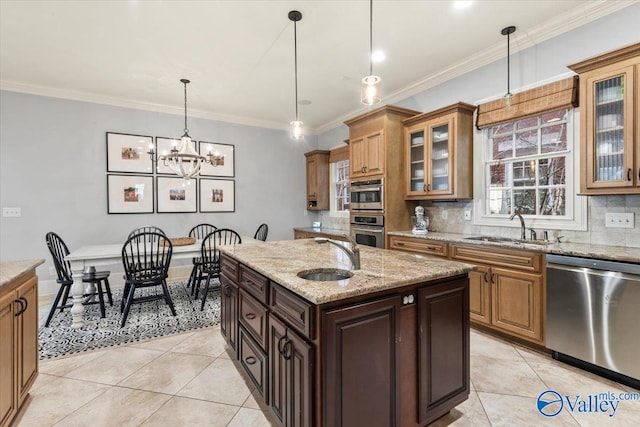 kitchen with sink, dishwasher, an island with sink, and backsplash