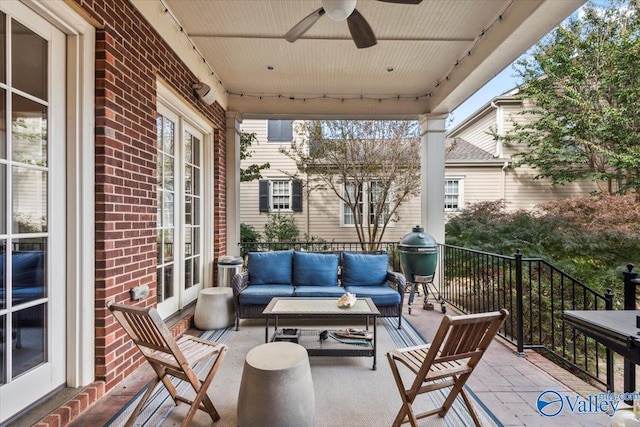 balcony with an outdoor living space and ceiling fan