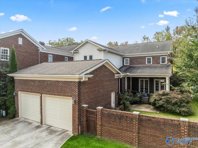 view of front of house featuring a porch and a garage