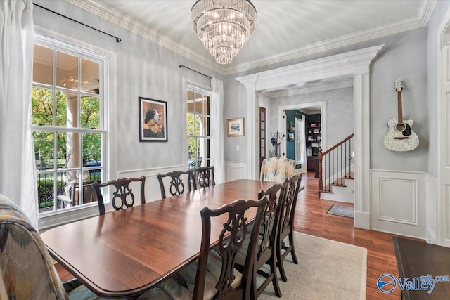 dining area featuring hardwood / wood-style flooring, ornamental molding, and plenty of natural light