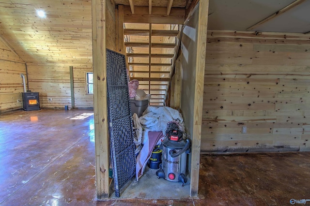 miscellaneous room with vaulted ceiling and a wood stove