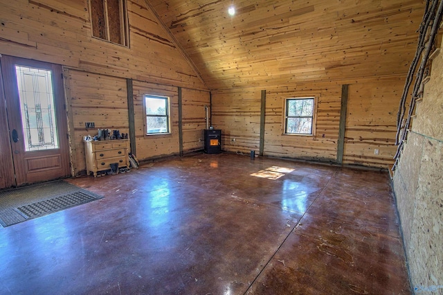 interior space featuring wood ceiling, wooden walls, and high vaulted ceiling