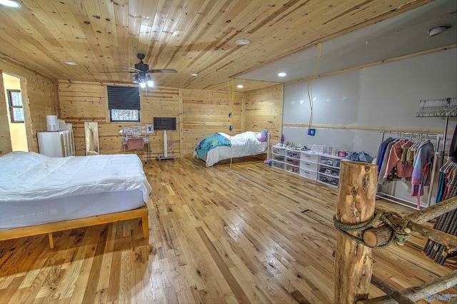 bedroom featuring wood-type flooring, wooden walls, and wood ceiling