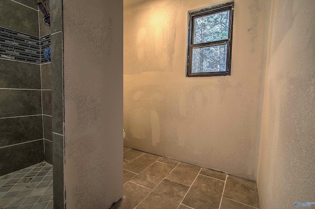 bathroom with a tile shower